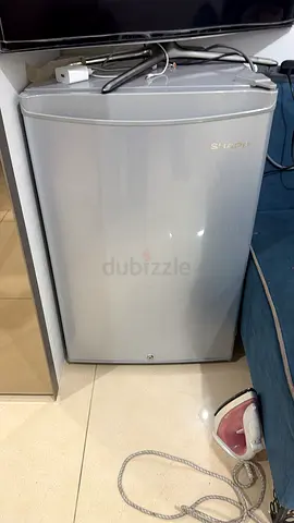 Compact single-door mini fridge in silver - good condition