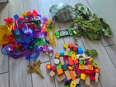 Assorted kids toys bundle: wooden blocks, marble run pieces, toy soldiers  more