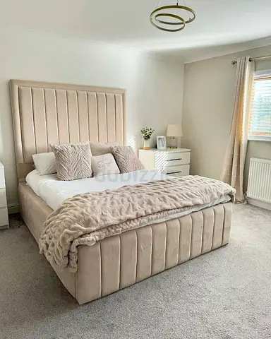 Beige upholstered double bed with storage — good condition