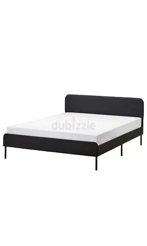 Queen bed frame with mattress and patterned bedspread - good condition