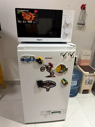 Compact single-door fridge in good condition with microwave