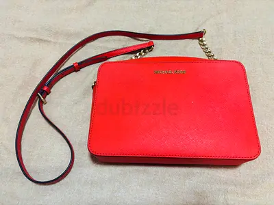 Orange MK leather crossbody clutch bag with gold chain strap