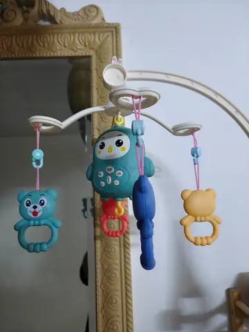 Baby crib mobile with musical penguin and rattles - gently used