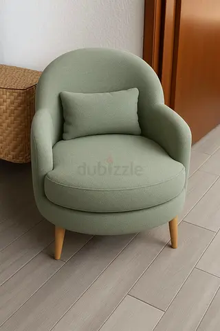 Light green single accent armchair with wooden legs