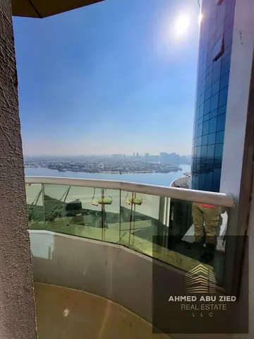 VIP 2-bedroom apartment with hall for annual rent in Ajman – Orient Towers, Al Mina St. Fully furnished, sea view balcony, central AC, private parking