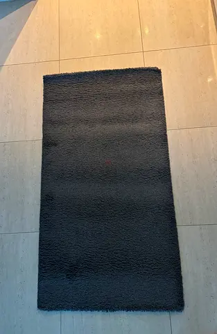 Dark grey rectangular $%! rug - good condition