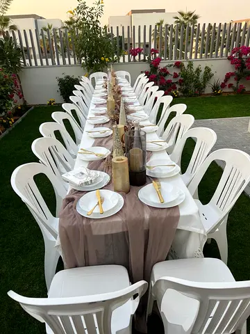 3 foldable indoor/outdoor dining tables with 30 white plastic chairs