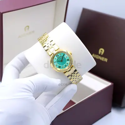 Aigner womens gold-tone wristwatch with turquoise dial, with box