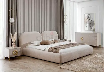 Low-profile upholstered king bed with matching bedside tables and dresser