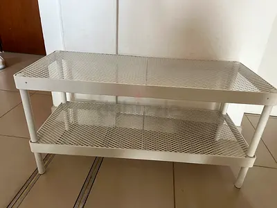 White metal two-tier mesh shelf / shoe rack — good used condition