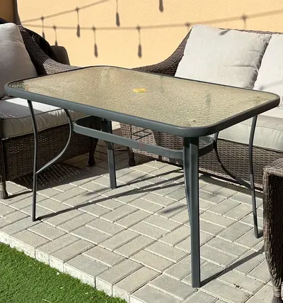 Outdoor glass-top patio table with metal frame