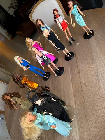 The collection of fashion dolls with stands — mixed condition