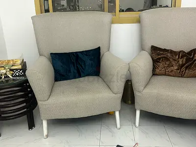 Pair of beige upholstered single armchairs in good condition