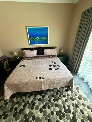 King-sized solid wooden bed frame with headboard. Comes with dresser and 2 side tables