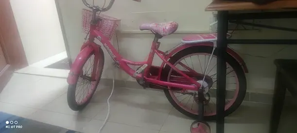 Pink kids bicycle with training wheels - good condition