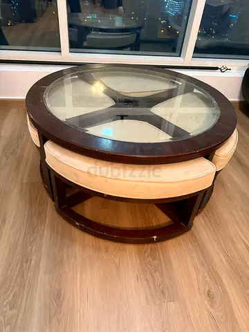 Round glass-top coffee table with built-in stools