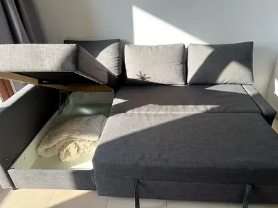 Compact grey fabric L-shaped sofa bed with storage - good condition