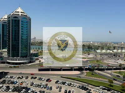 Annual rental in Al Qasimia Al Nad: Spacious 2BR hall with sea view, balcony, free parking, modern finishing, and easy access to Dubai.
