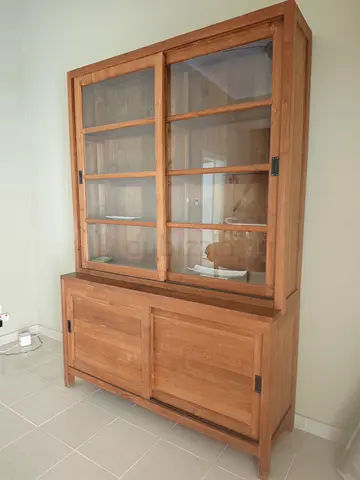 Solid teak display cabinet with sliding glass doors and lower storage cabinet.