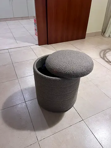 Small round grey fabric storage seat / ottoman / pouf