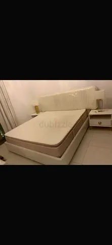 Queen bed frame with mattress and two bedside tables - beige/cream