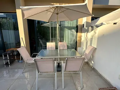 Outdoor Dining Set for Sale 6 chairs, glass-top table, and umbrella included.