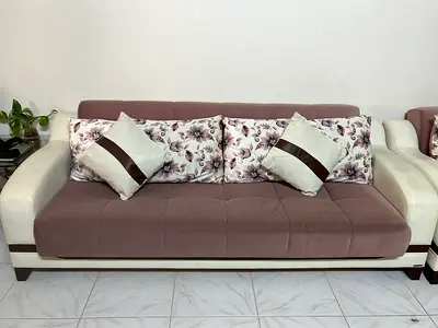 Comfortable Mauve and White Sofa with Decorative Pillows and storage