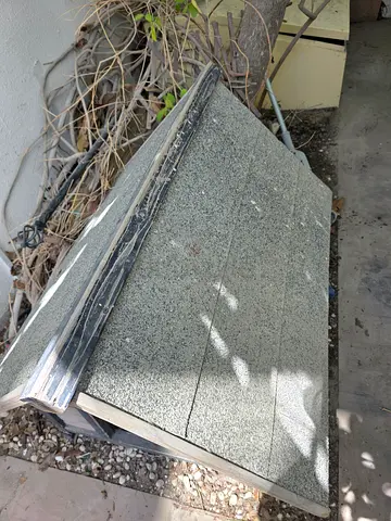 Used outdoor dog house / pet shelter - weathered roof