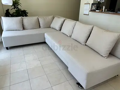 Light grey L-shaped sectional sofa - good condition. Turns into a sofabord 160x200.