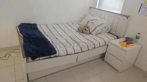 Single white wooden bed with storage drawers and bedside table - good condition