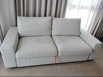 Beige 2-seater fabric sofa bed in good condition