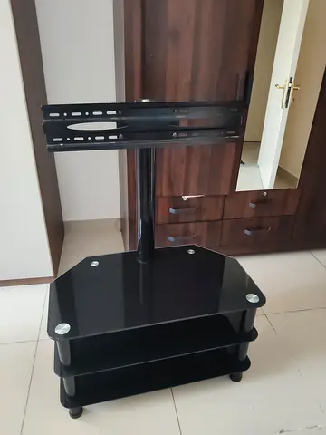 Black glass TV stand with mount and shelves