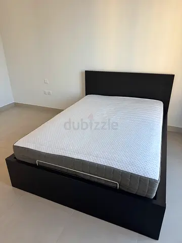 Modern dark wood platform bed frame with mattress included
