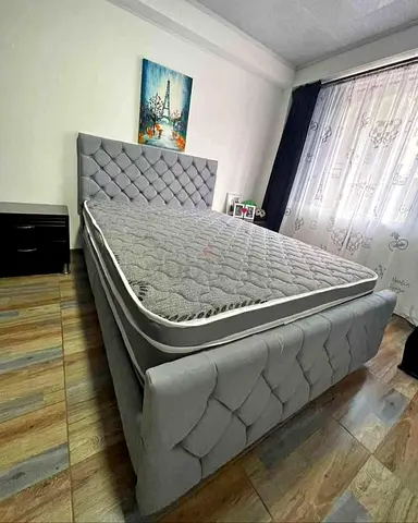 Queen-sized upholstered bed frame with mattress - light grey
