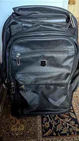 Black travel backpack / rolling carry-on in good condition