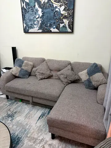 Light grey fabric L-shaped corner sofa with cushions, sofa cum bed - good condition