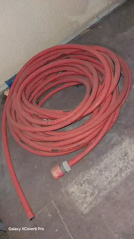 Used long red garden/utility hose - good condition