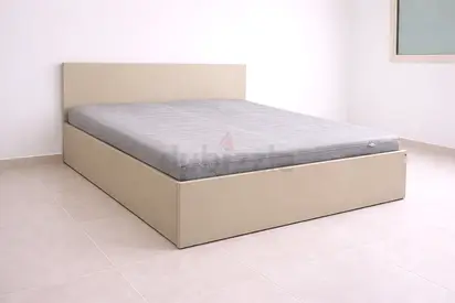 Simple beige upholstered double bed frame with mattress