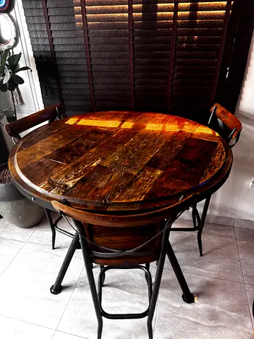 Round rustic wooden dining table with metal legs