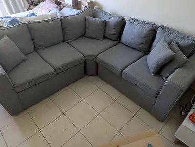 Light grey L-shaped fabric corner sofa  — compact 4-seater, good condition  coffee table like n