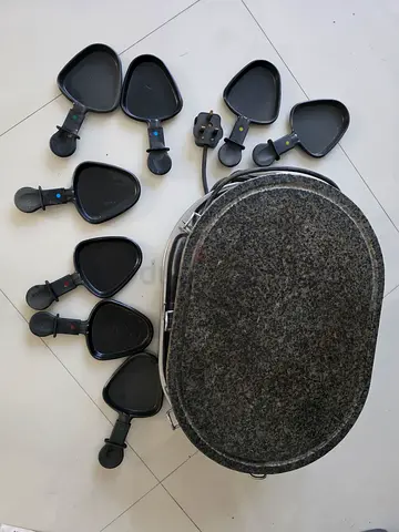 Electric raclette grill with 8 individual pans and stone top - used2
