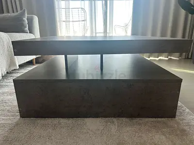 Modern coffee table in a stylish concrete-grey finish. Features a rotating/swivel top