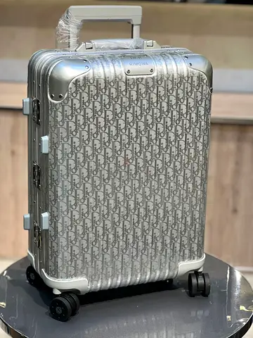 Dior and Rimowa aluminum carry-on suitcase