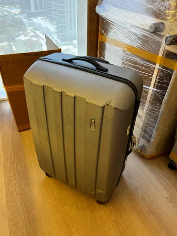 Large silver hard-shell suitcase with wheels - used