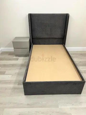 Single grey upholstered bed frame with winged headboard