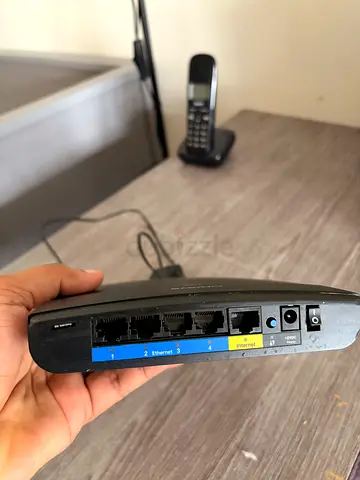 Used wireless router with phone port and 4 LAN ports - working condition