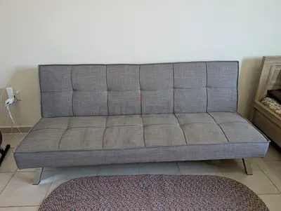Grey fabric futon sofa bed — good condition