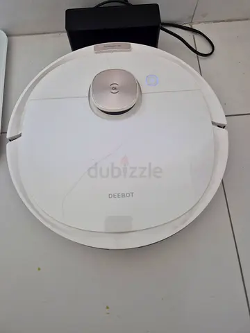 Used robot vacuum cleaner — compact circular design, working condition