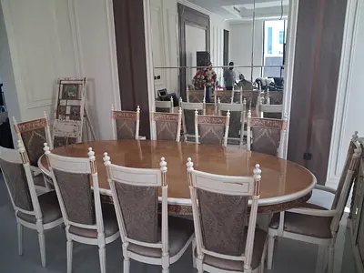 Elegant wooden dining table with 10 matching chairs