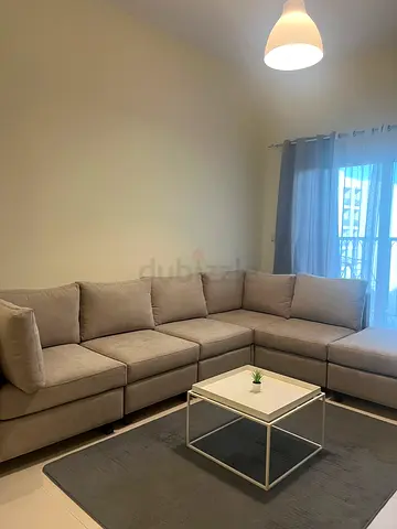 Light grey L-shaped sectional sofa in good condition